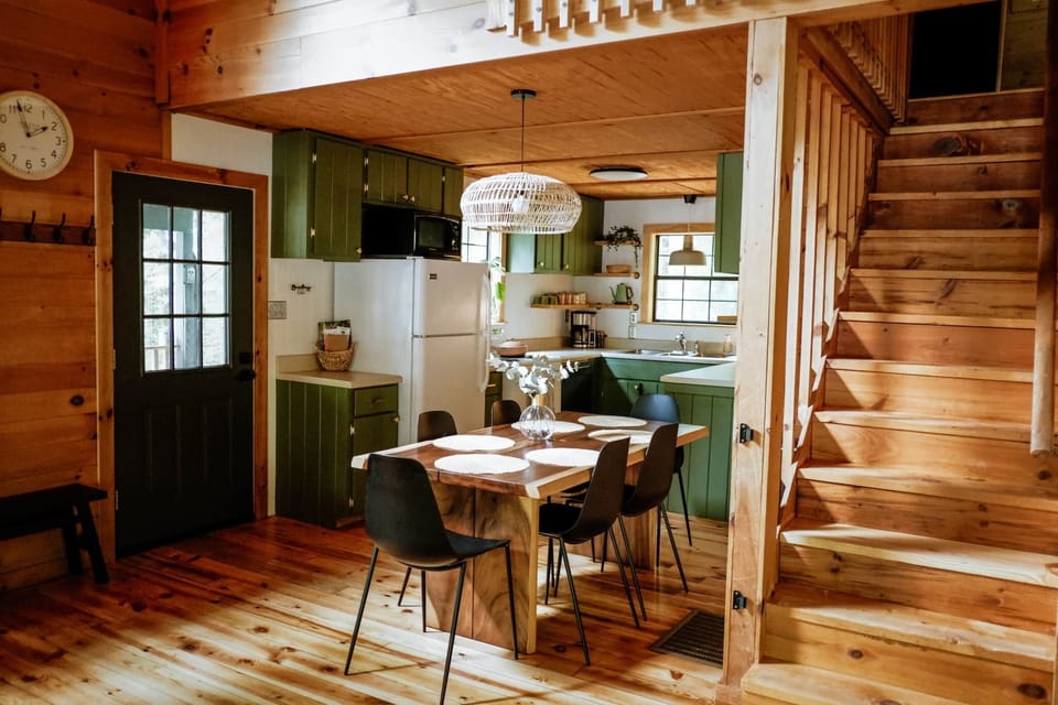 Dining for 6 & kitchen located underneath the loft. Side door leads to deck & fire pit.