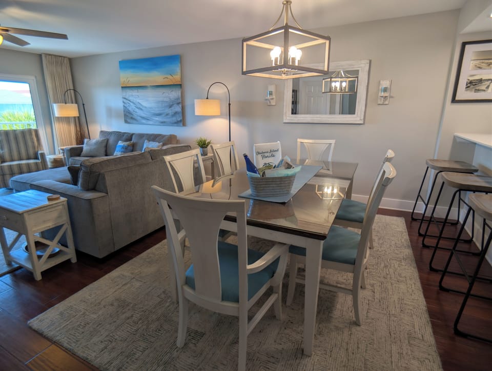 Bright coastal open-plan with dining for six and bar seating.