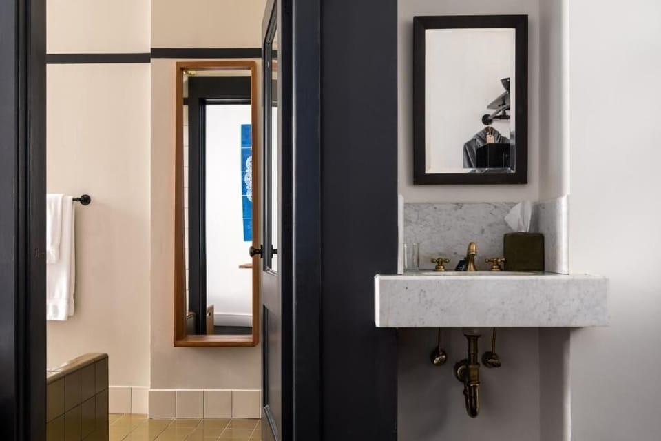 Start your day at a chic marble vanity with brass fixtures.