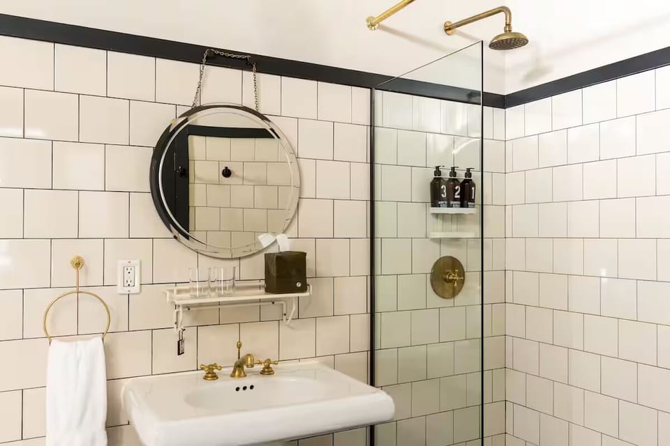 Refresh under a rainfall shower in crisp, tiled elegance.