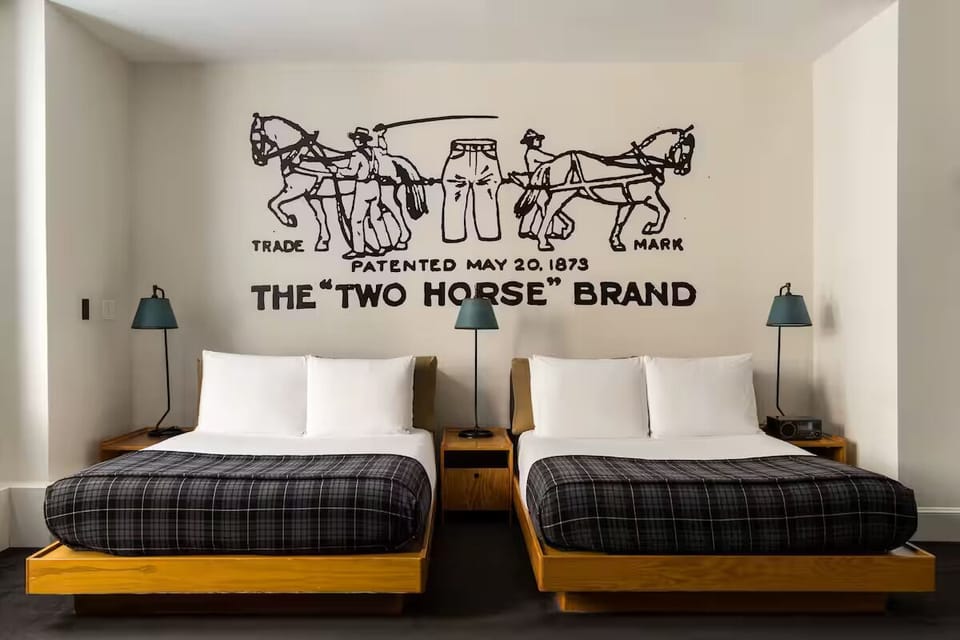 Settle into two plush beds beneath bold, iconic wall art.