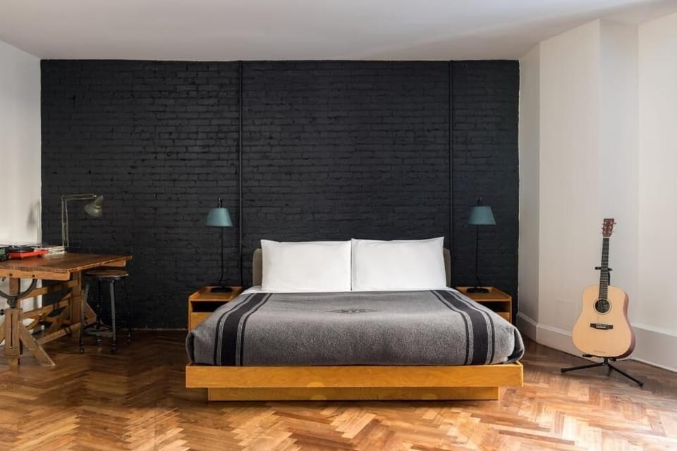 Unwind in a serene king bed with warm wood tones.