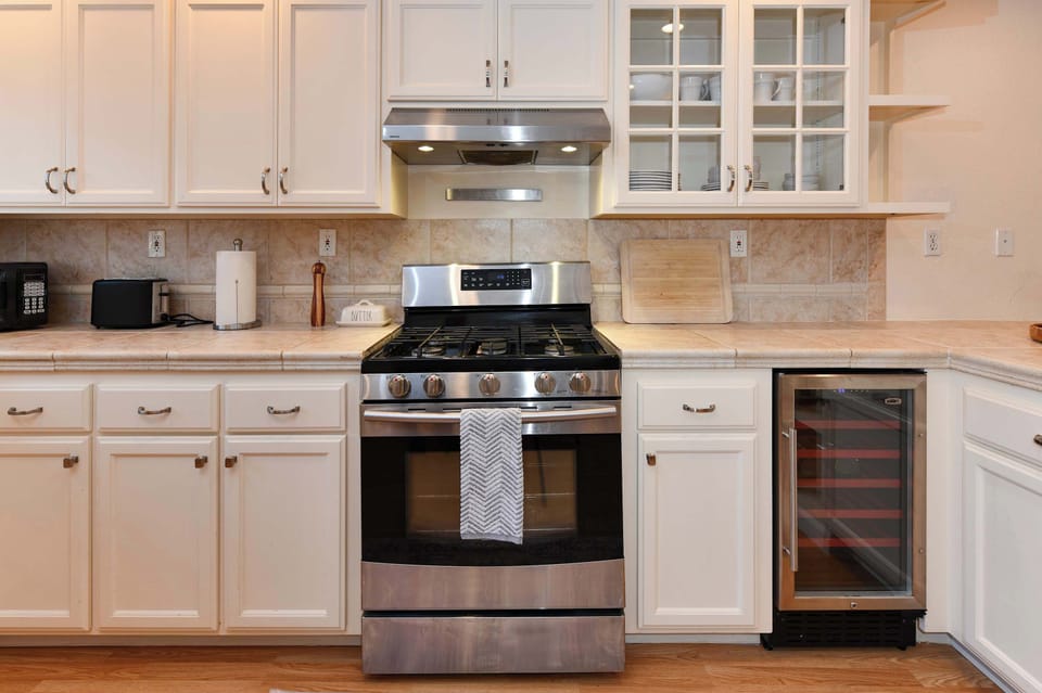 Clean and inviting kitchen featuring ample cabinetry, natural light, and a convenient island for easy meal prep.