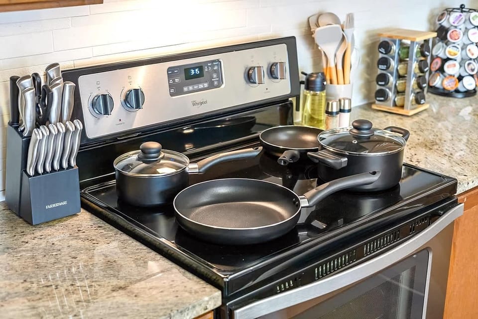 Kitchen stove area featuring quality cookware and utensils ready for use. Whether preparing a full meal or a quick breakfast, this setup makes cooking simple, efficient, and enjoyable.