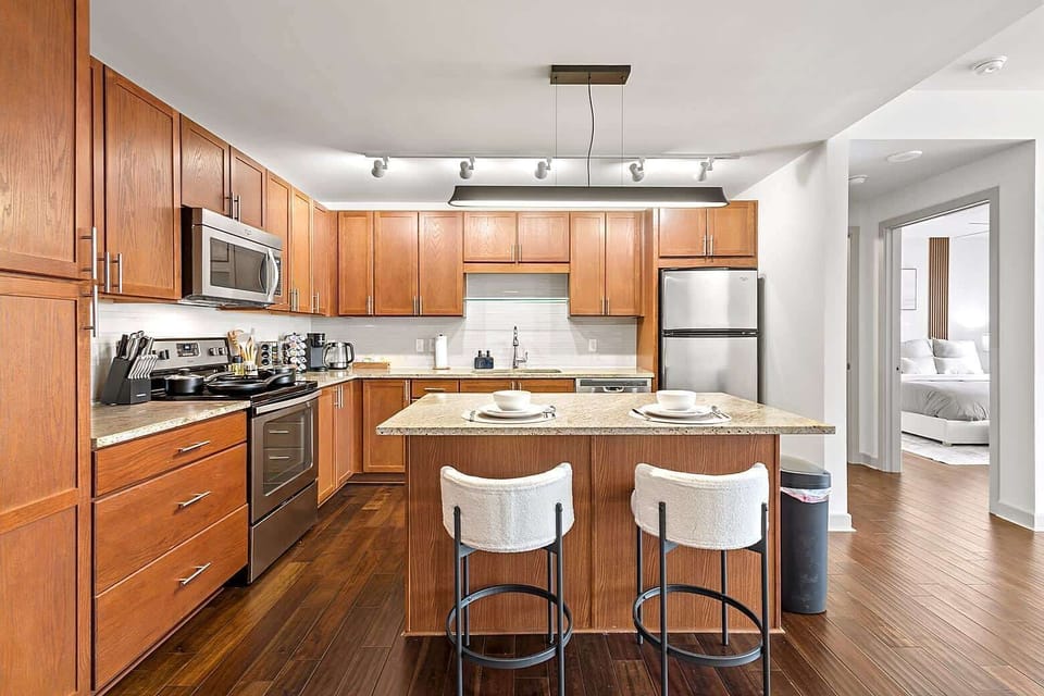 Kitchen island with bar seating, perfect for casual dining, morning coffee, or remote work. The open design connects seamlessly with the living area, making it easy to cook, eat, and relax in one shared space.