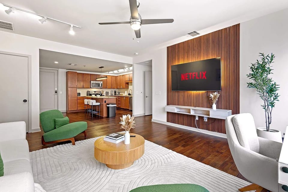 Open concept living room connecting seamlessly to the kitchen and dining area. Designed for comfort and flow, this space is perfect for lounging, entertaining, or enjoying your stay with plenty of room to spread out.
