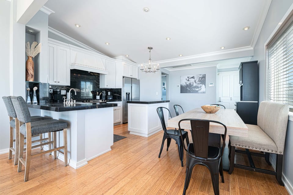 Gather for meals at the dining table for six, with additional bar-top seating for two
                
