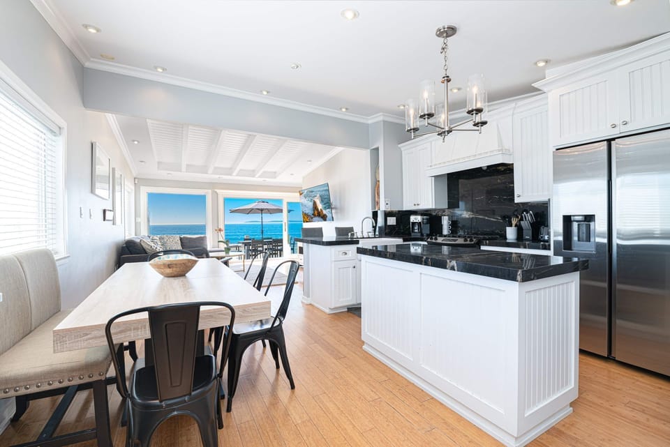Dine, unwind, and cook with the ocean in view through expansive glass windows that open directly to the oceanfront balcony
                