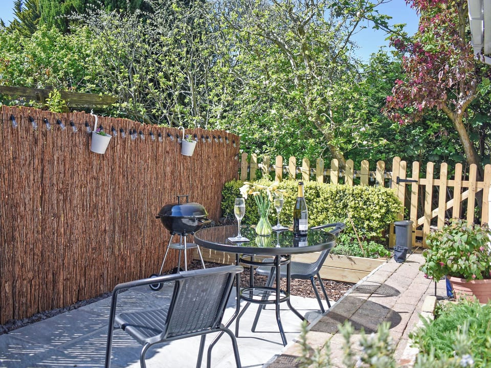 Fully enclosed sunny seating area with BBQ | Treetops, Baildon