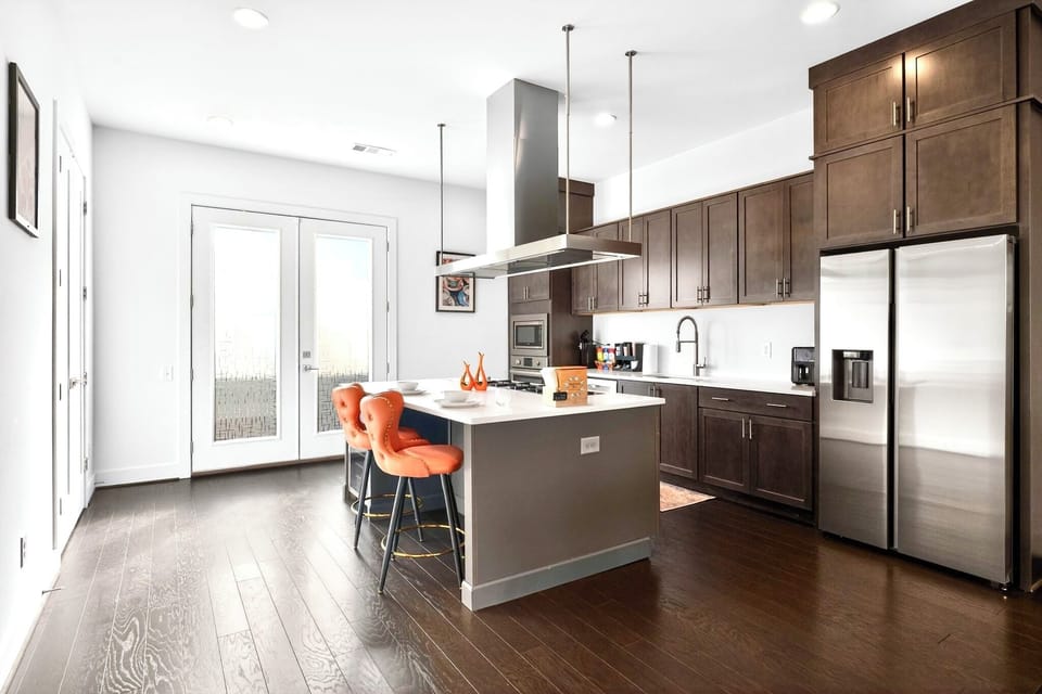 Modern chef’s kitchen with island seating and stainless steel appliances