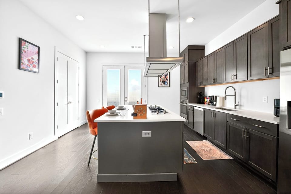 Bright modern kitchen with large island, gas cooktop, and stylish seating