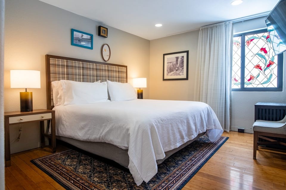 Stretch out in a calm, airy bedroom with plush bedding.