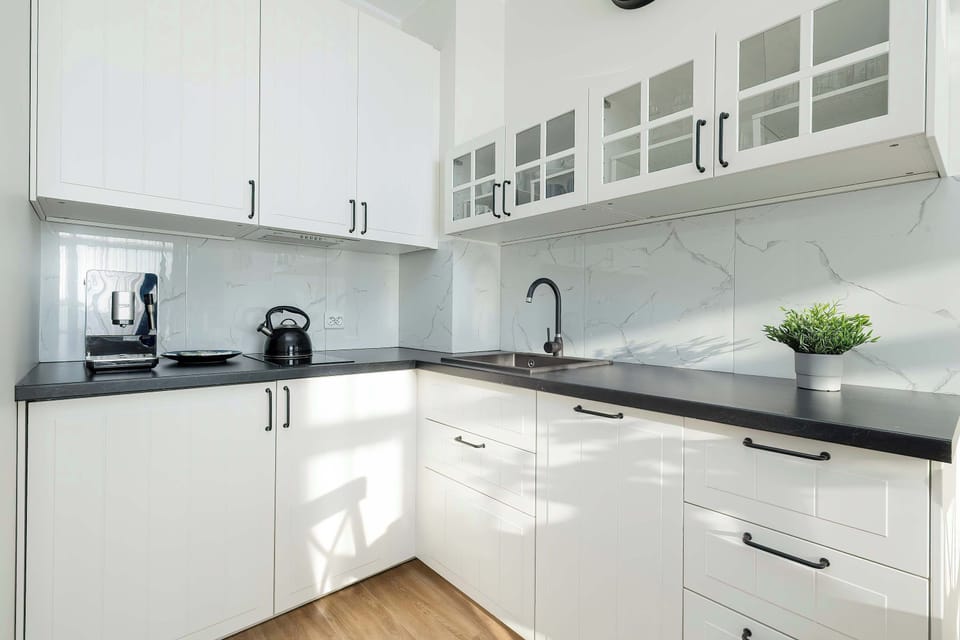 The sleek design of the kitchenette blending seamlessly with the living area.