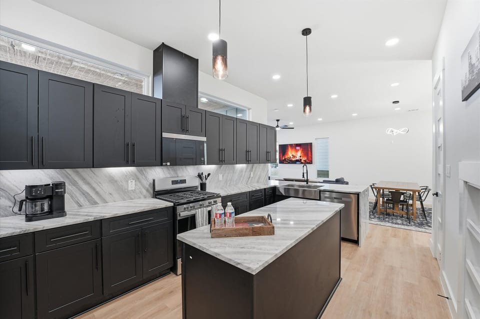 Roomy kitchen island and 3 person bar behind the sink for gathering. 