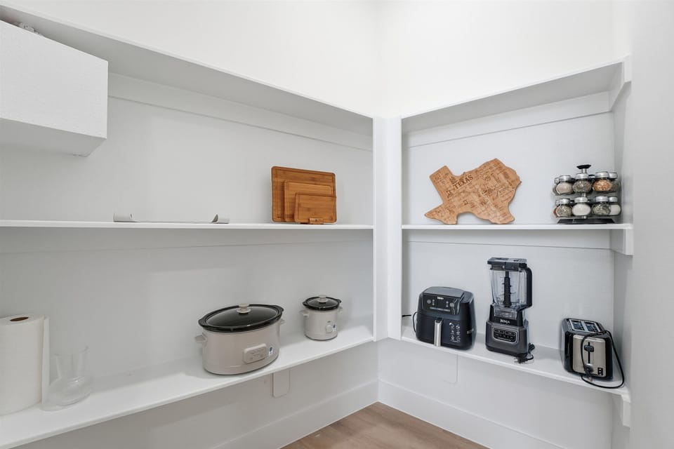 Pantry has essential small kitchen appliances and a full seasoning rack. 