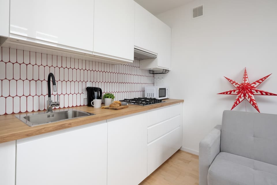 The sleek design of the kitchenette blending seamlessly with the living area.