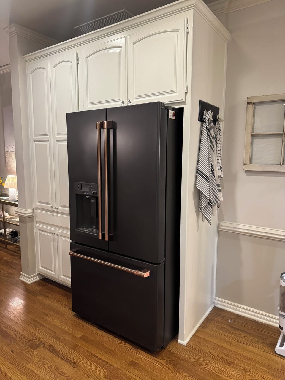 Matte black GE Cafe fridge with bronze handles
