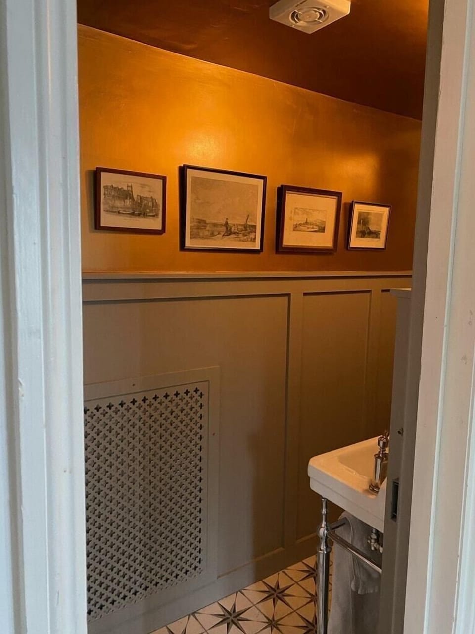 A characterful downstairs Cloakroom/WC showcasing antique Cromer prints.