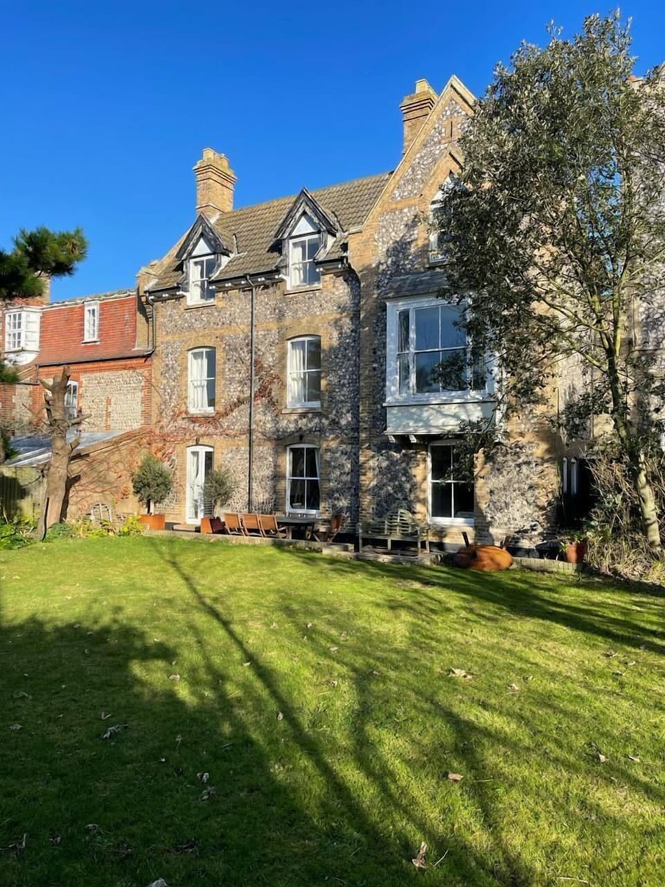 Rear view of Bracondale House, opening on to a terrace, perfect for outdoor dining and a large south facing enclosed garden for ball games badminton etc.