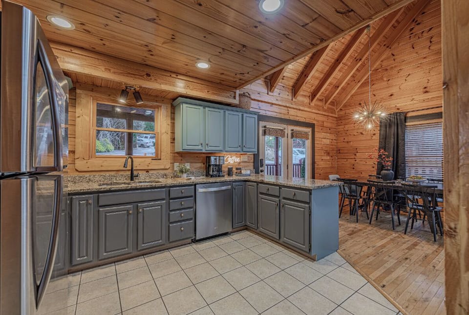 Your fully-equipped kitchen features countertops and stainless appliances, perfect for preparing meals while staying connected to your group.
