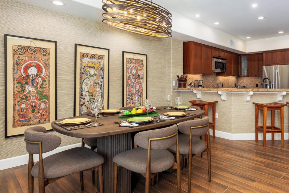 Gather around this elegant dining space where meaningful conversations flow as naturally as the warm lighting overhead.