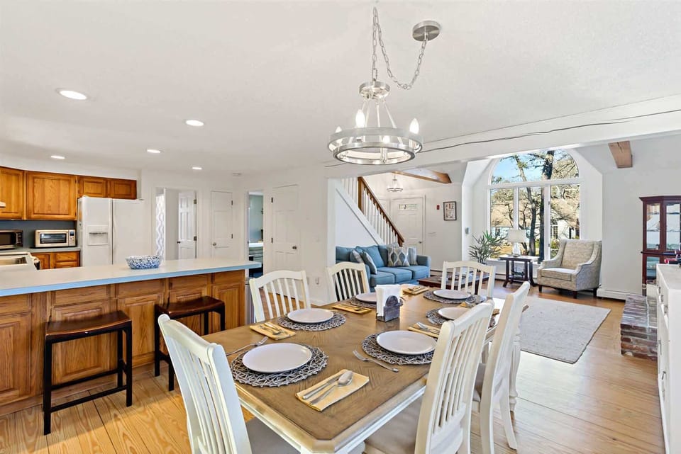 Dining table and kitchen breakfast bar, great for family meals and planning your Cape Cod adventures.