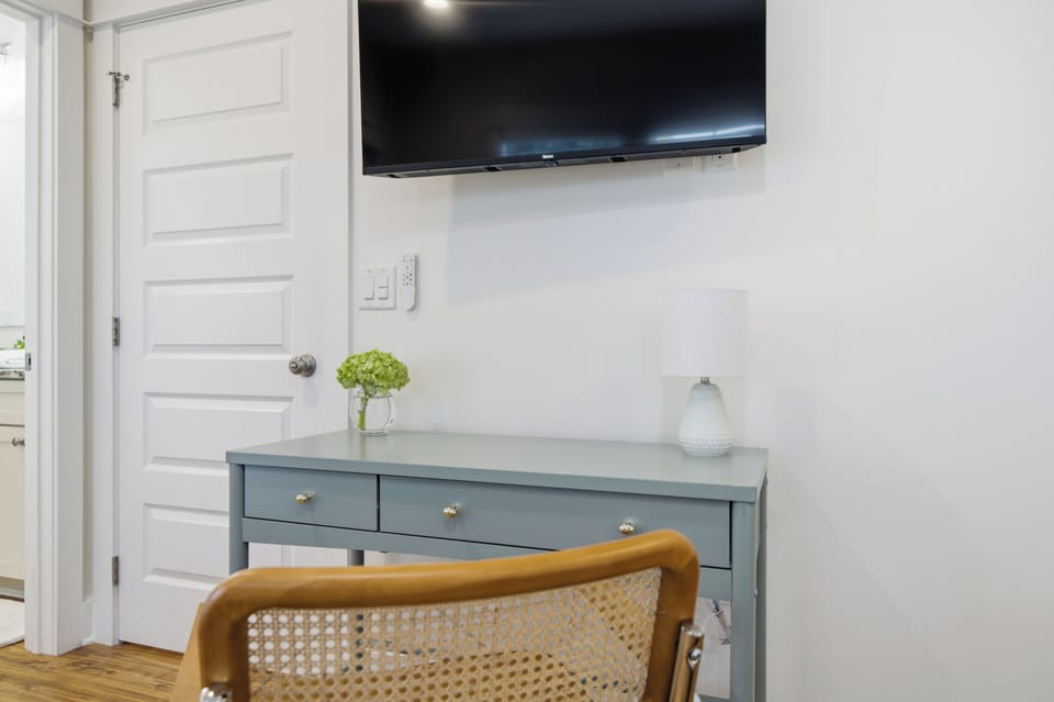 Bedroom workspace with desk and TV—ideal for light remote work