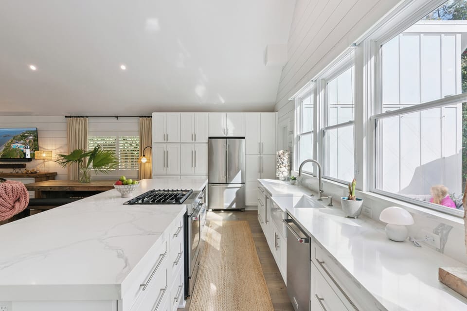 Your gourmet kitchen awaits with marble counters, stainless appliances, and sunlit windows perfect for morning coffee rituals.