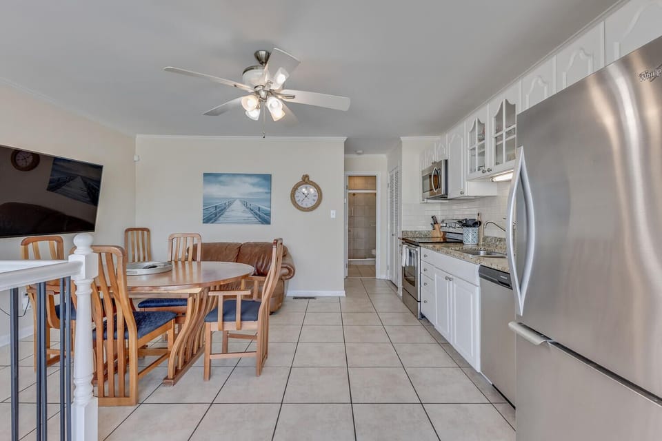 Relax in your open-plan space with coastal artwork and modern conveniences perfectly positioned for memorable meals together.