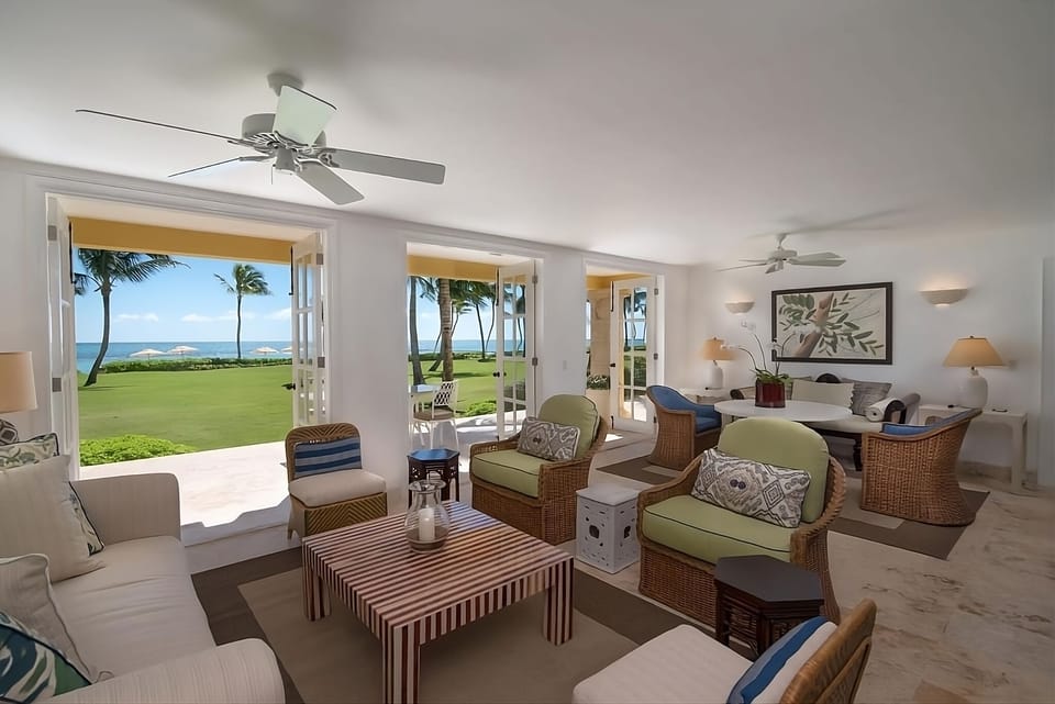 Gather in the airy lounge while doors open to the sea