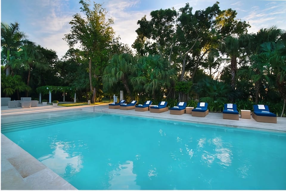 Float in a sparkling pool framed by lush greenery.