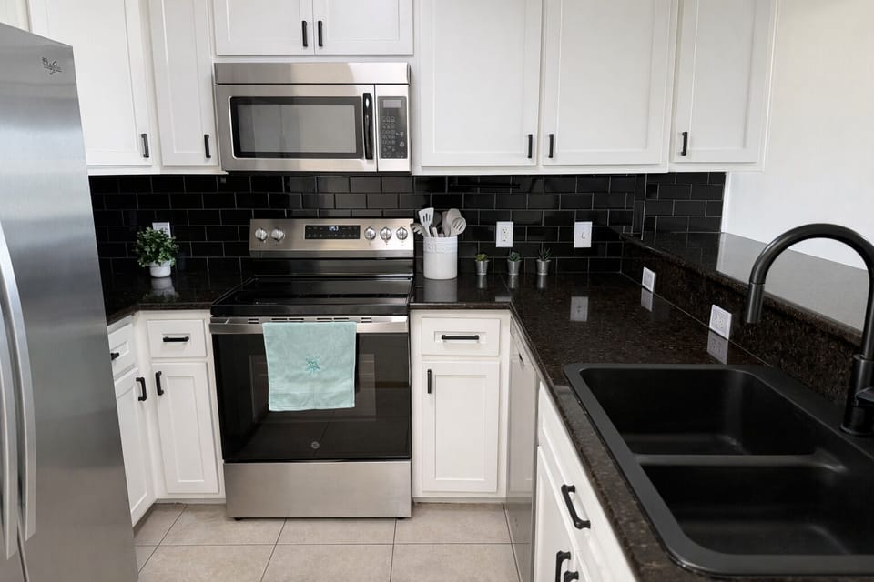 Fully equipped kitchen with stainless steel appliances.