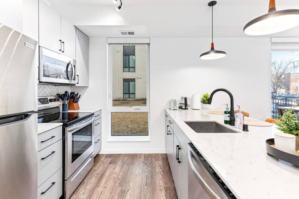 Fully Equipped Kitchen: Features stainless steel appliances, a coffee station, and ample cabinet space.