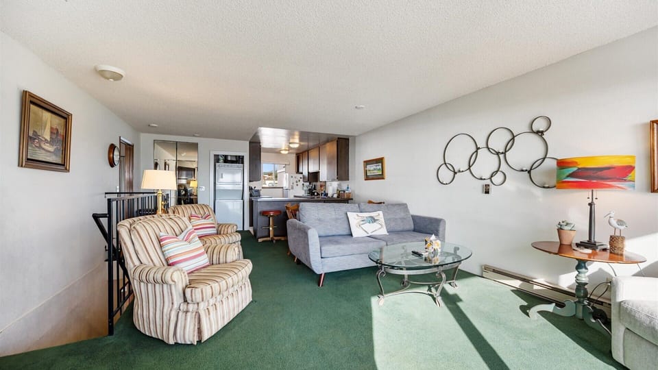 The open concept living and kitchen space offers a spacious area to relax and enjoy the views