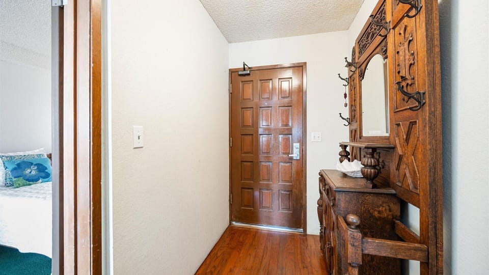 Entry to the home showcases the rich woods and ornate furnishings that add timeless charm to your vacation