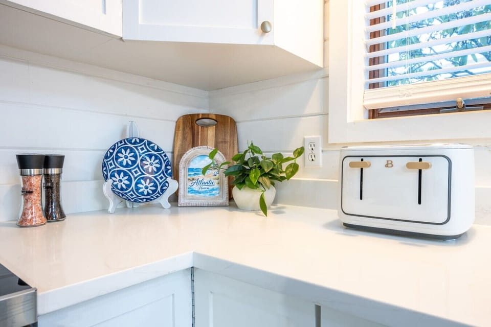 Clean, modern, and brand new. Sleek quartz countertops and fresh finishes give the kitchen a bright, polished feel guests love.