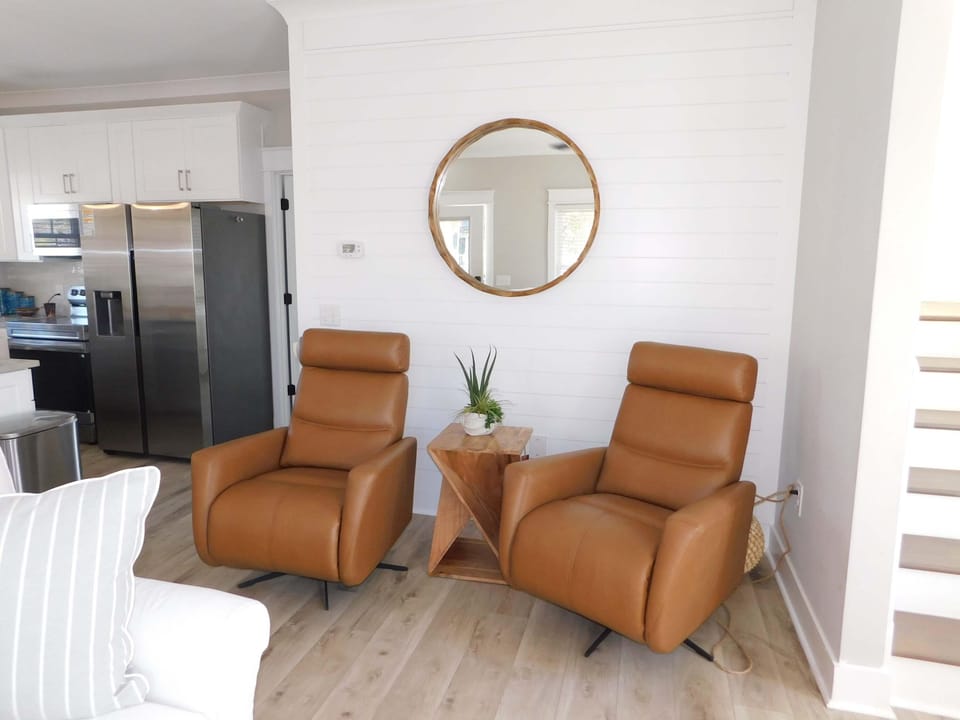 Cozy living room nook with sleek kitchen access and natural light