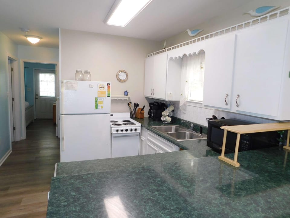 Bright, cozy kitchen with ample counter space for cooking
