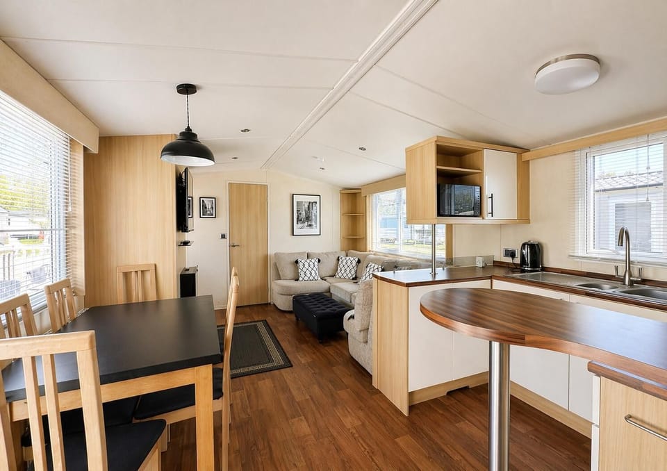 The dining table in this modern caravan seats 4 comfortably, serve up the family favourites from the adjoining kitchen before grabbing the boards games for a fun filled night in the family will love.