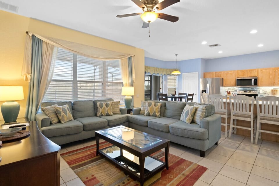 Spacious living room with plush sectional seating, natural light, and smart TV for family gatherings