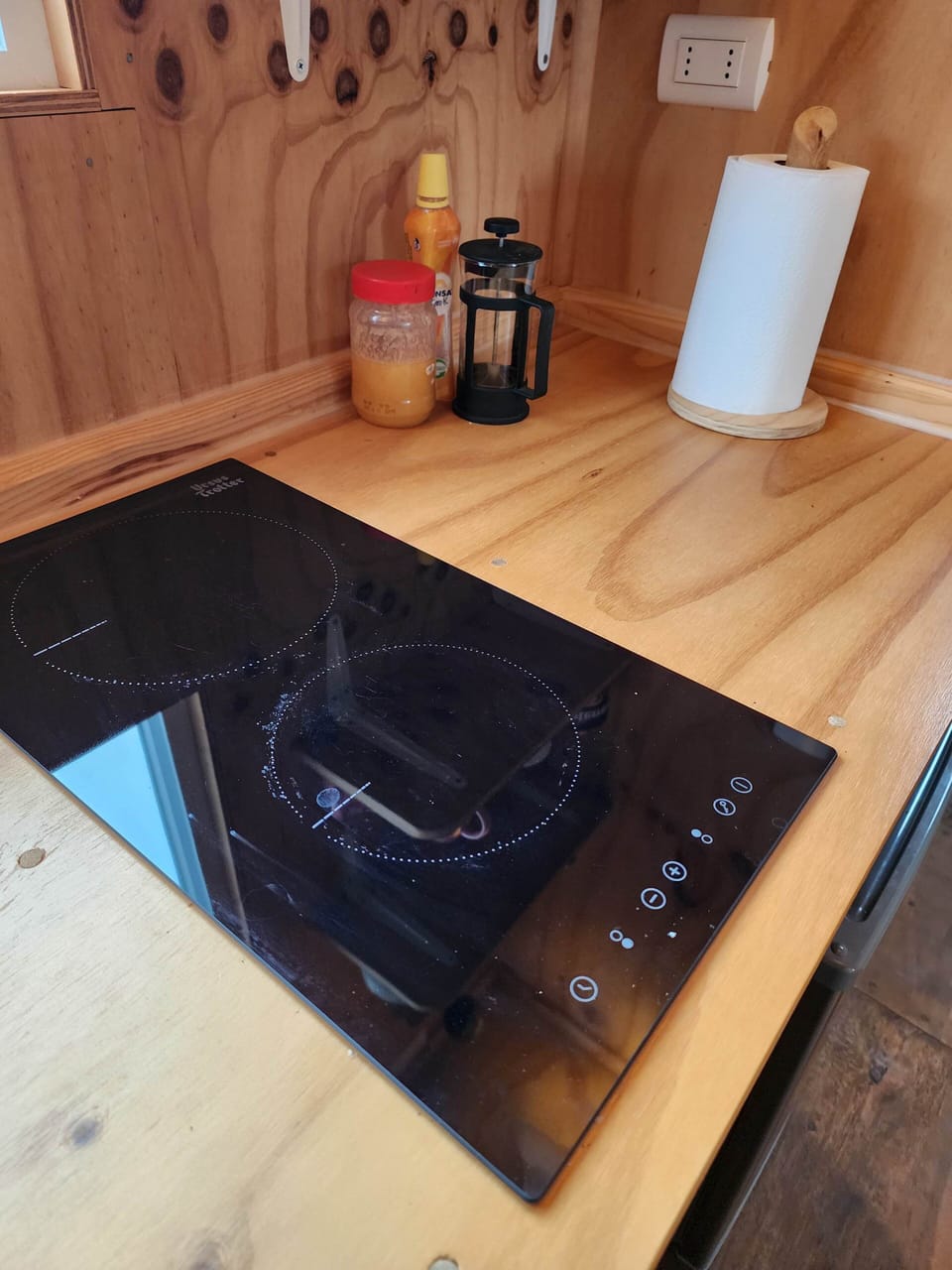 Sleek cooktop set into wood counter for simple, convenient meals.