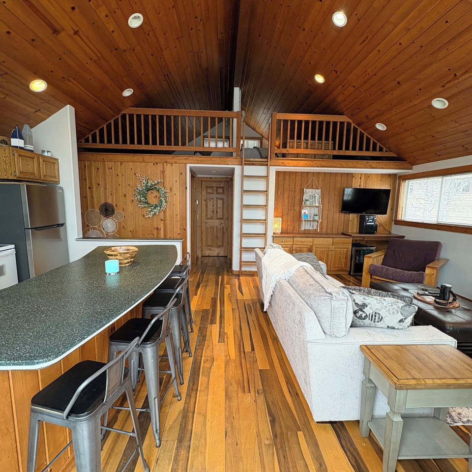 Open kitchen/living room with loft view