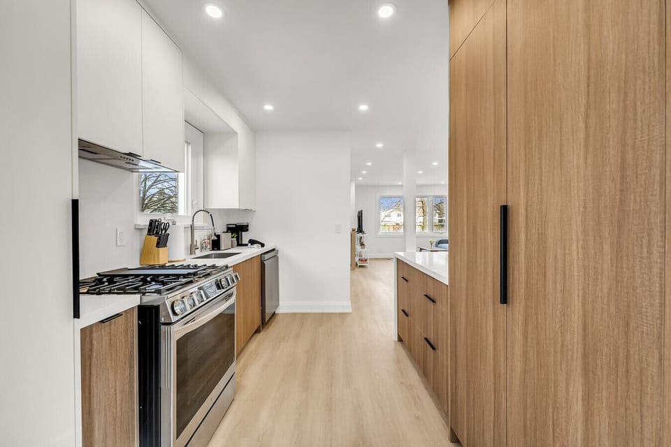 Chef-ready kitchen featuring stainless steel appliances, a gas range, white subway tile backsplash, and beautiful light wood cabinetry.