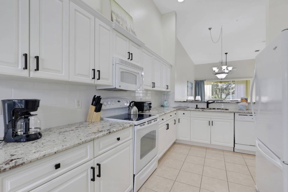 Cookware, dinnerware, many kitchen tools and small appliances are provided, including a drip coffee maker.