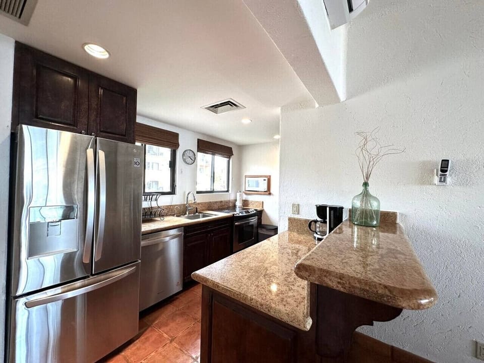 Modern chef’s kitchen with stainless appliances and granite counters
