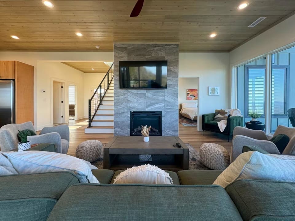 Centered view of the living room highlighting the fireplace and TV.