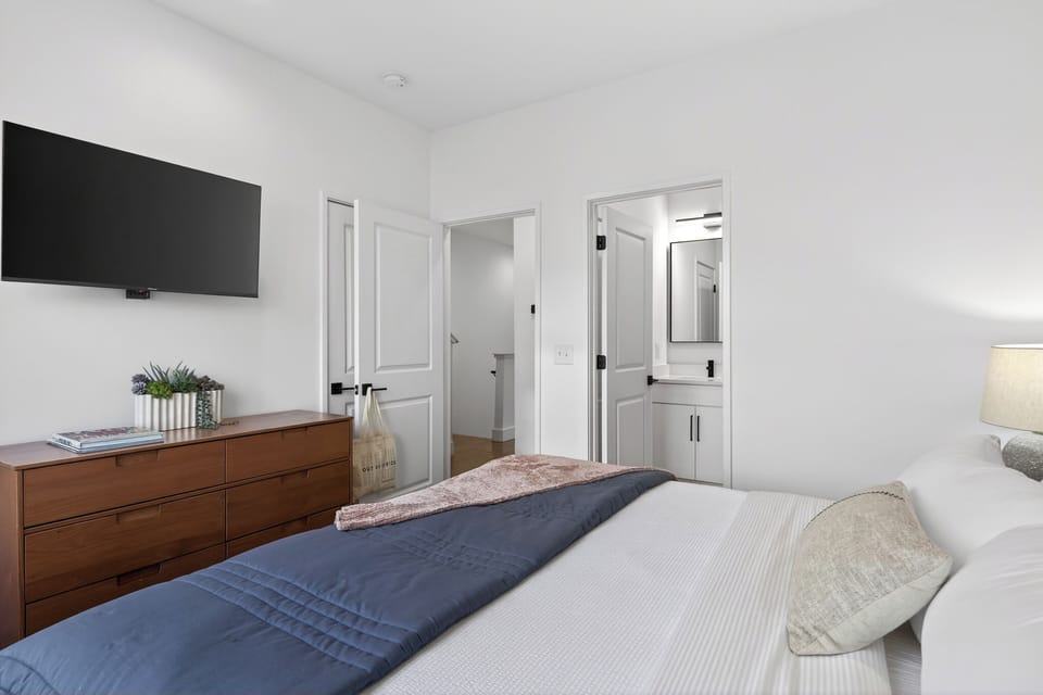 Bedroom 4 features a king bed, TV and an ensuite bathroom.