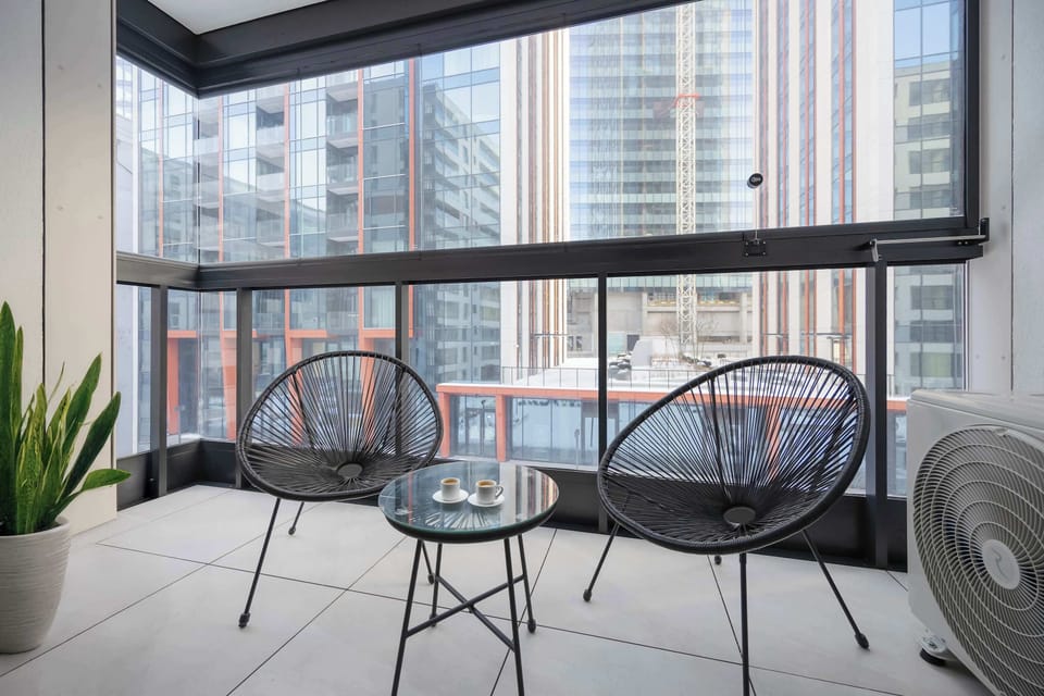 Private balcony with seating and city views.