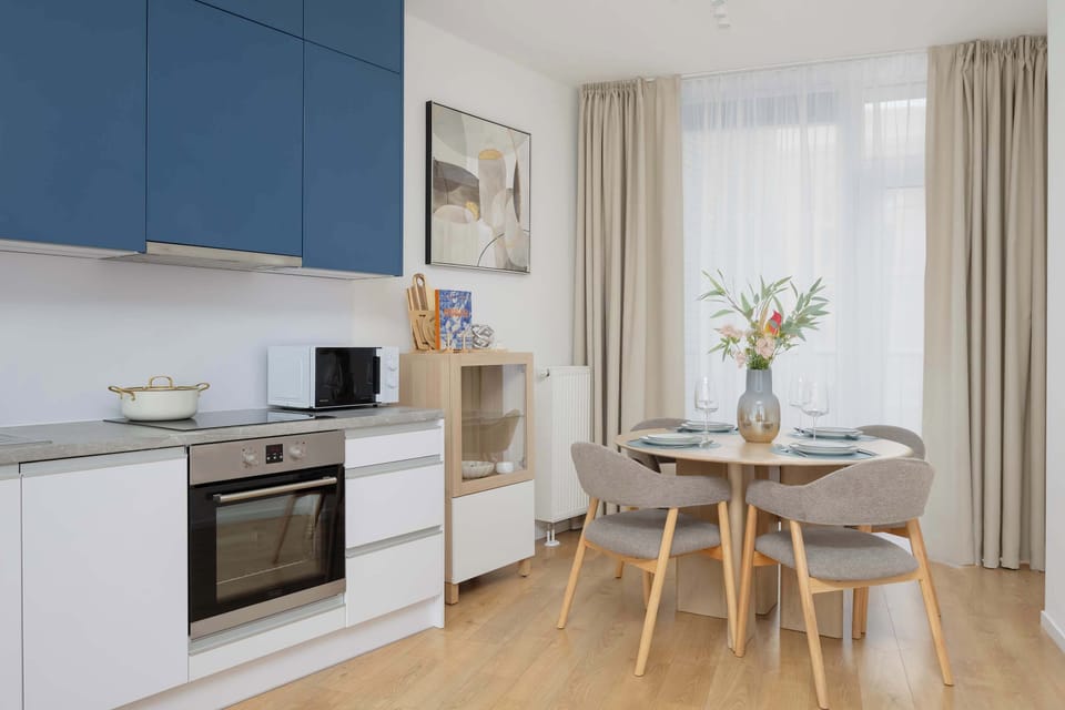 Kitchen and dining area with blue cabinetry.
