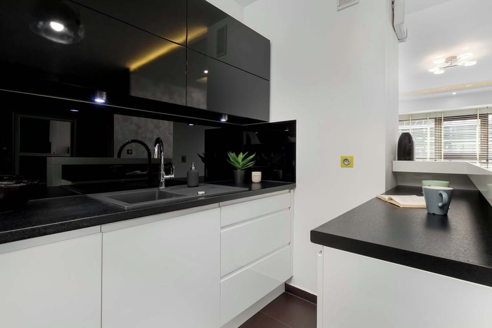 A close-up of the kitchen appliances including oven, induction cooktop, and sink, emphasizing usability and style.